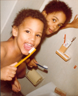 Benjamin as a young child in front, with his sister behind him